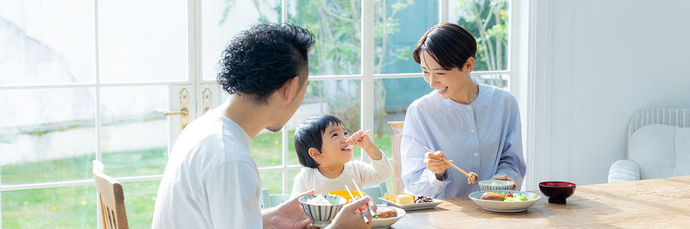A family enjoying a meal together at the dinner table.